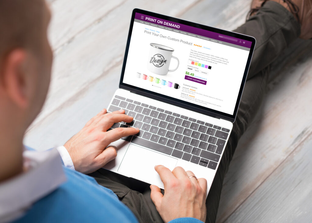 Man creating his own products by using print on demand service online