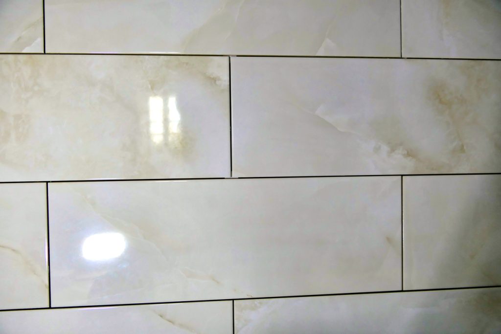 Reflections of light on the granite backsplash wall in the kitchen