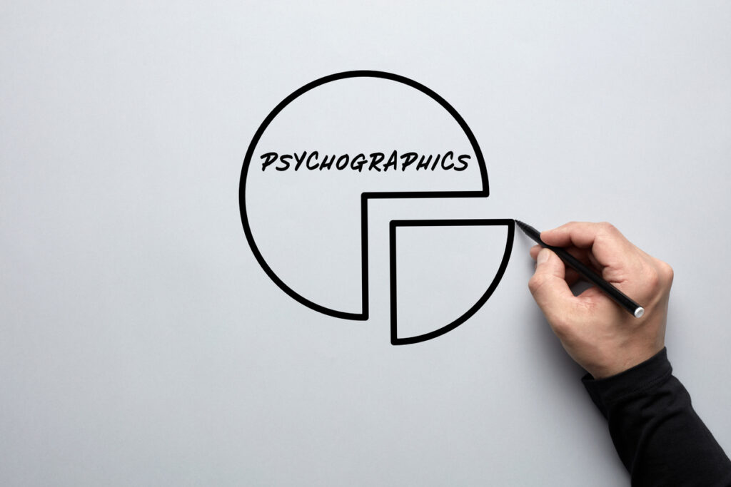Male hand drawing a pie chart with the word psychographics